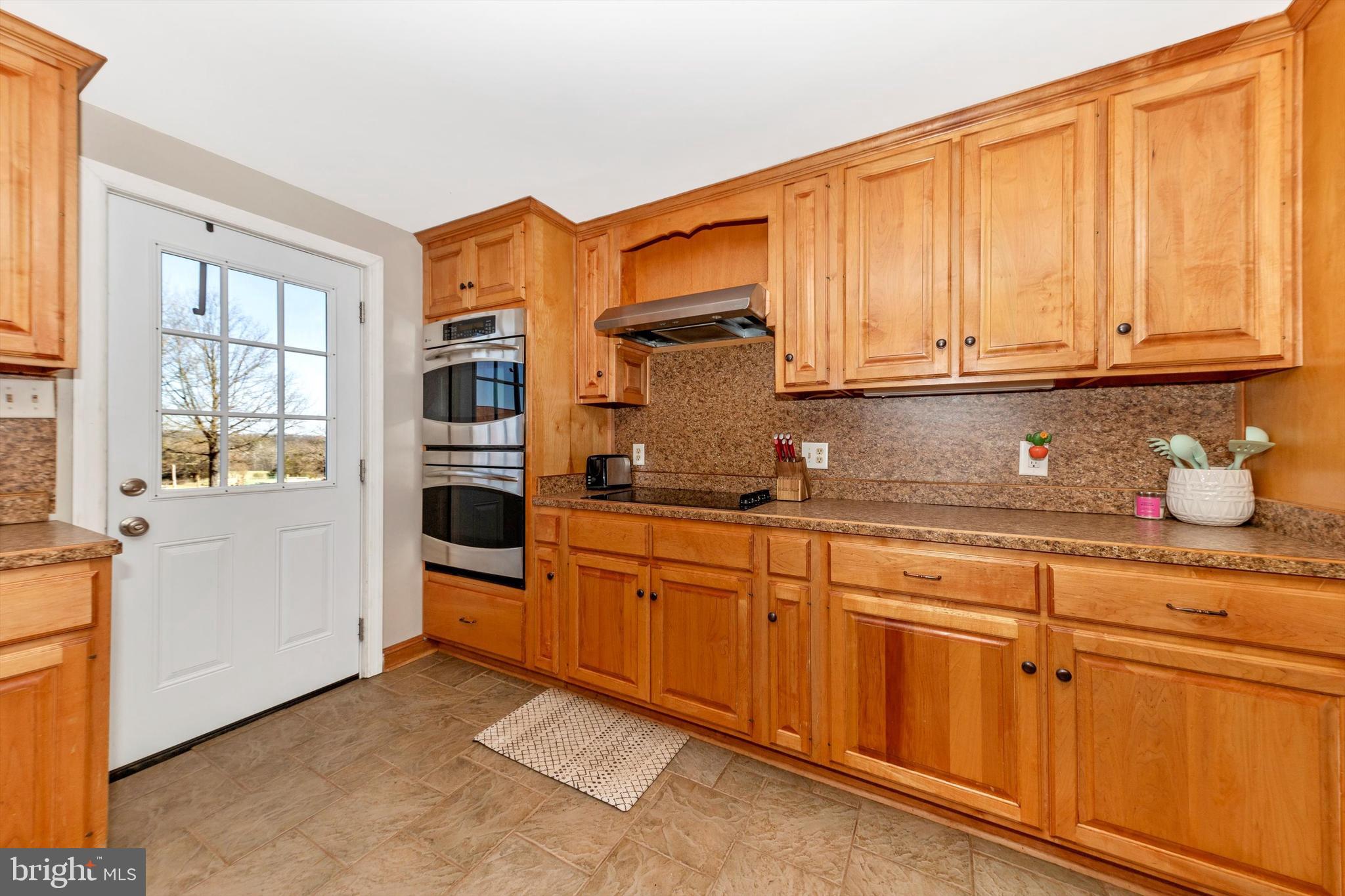 17449 Irishtown Road Emmitsburg, MD 21727 - Photo 7 of 77 a kitchen with stainless steel appliances granite countertop a sink and cabinets with wooden floor