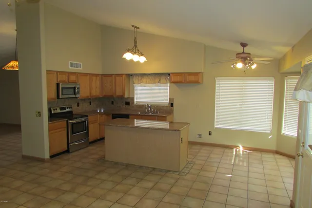 a kitchen with a sink cabinets and stainless steel appliances