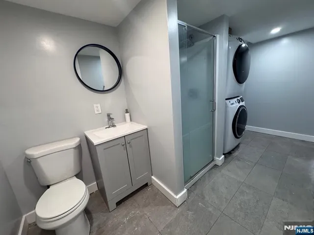 a bathroom with a toilet sink vanity and mirror