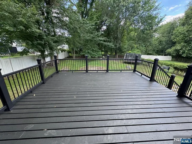 a view of a deck with a white fence