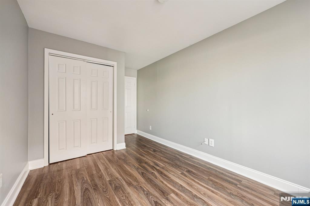 105 State Street, Unit 1H Hackensack, NJ 07601 - Photo 14 of 23 a view of an empty room with wooden floor