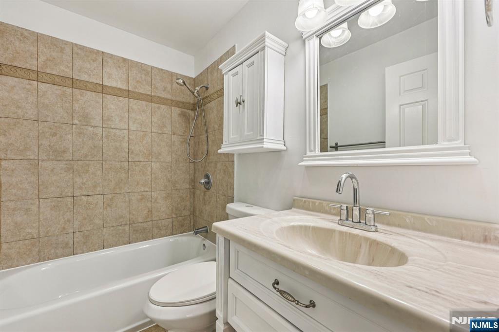 105 State Street, Unit 1H Hackensack, NJ 07601 - Photo 23 of 23 a bathroom with a sink a toilet and shower