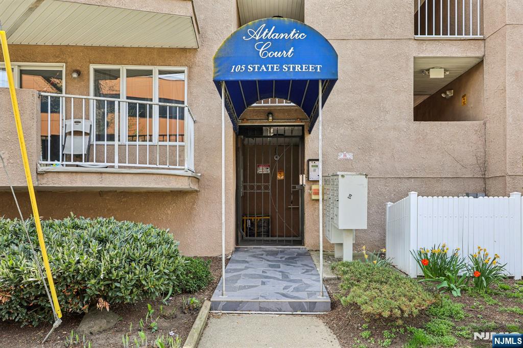 105 State Street, Unit 1H Hackensack, NJ 07601 - Photo 3 of 23 a front view of a house with a garden