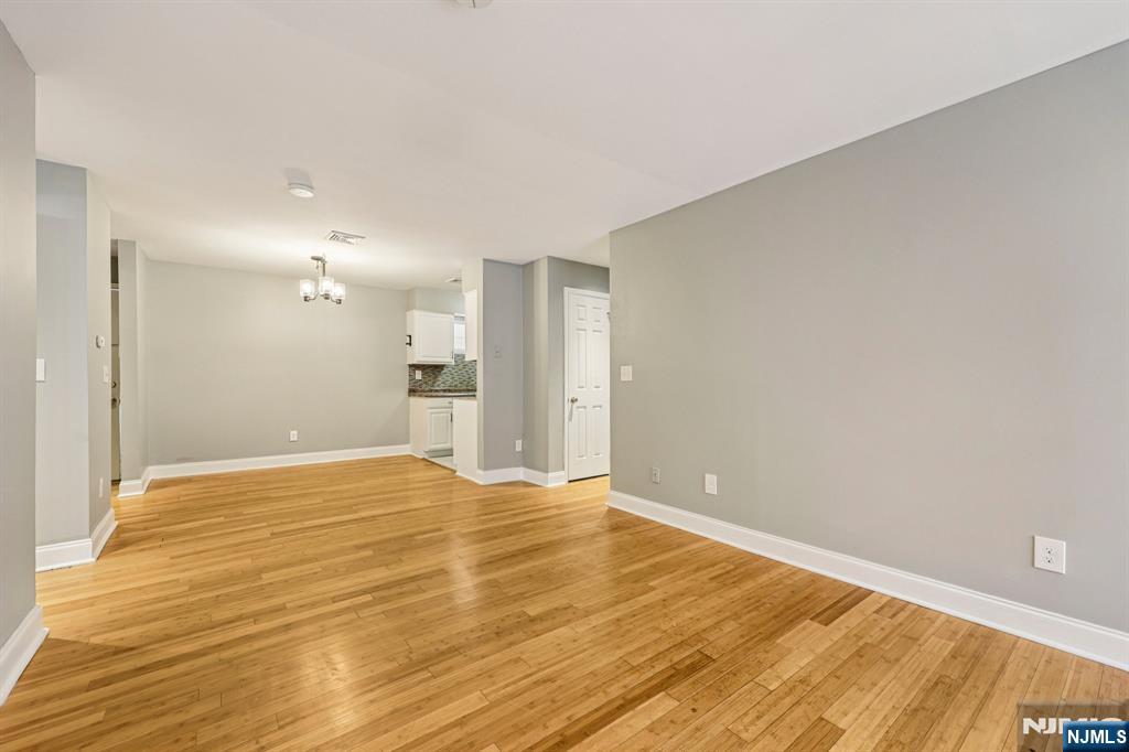 105 State Street, Unit 1H Hackensack, NJ 07601 - Photo 4 of 23 a view of empty room with wooden floor