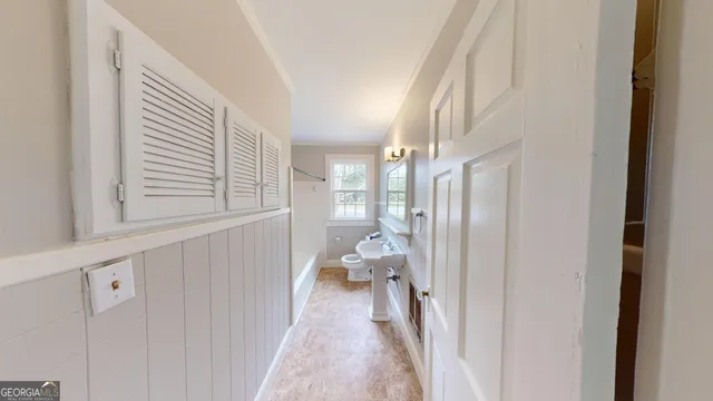 a view of a hallway view with wooden floor and staircase