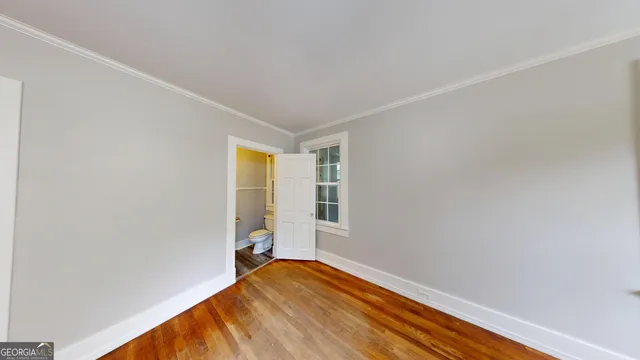 a bathroom with a toilet and a mirror