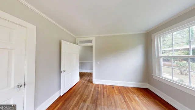a view of a yard in front of a house with a large tree