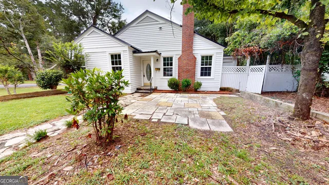 a view of a house with backyard and sitting area