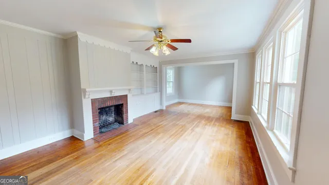 wooden floor in an empty room with a window