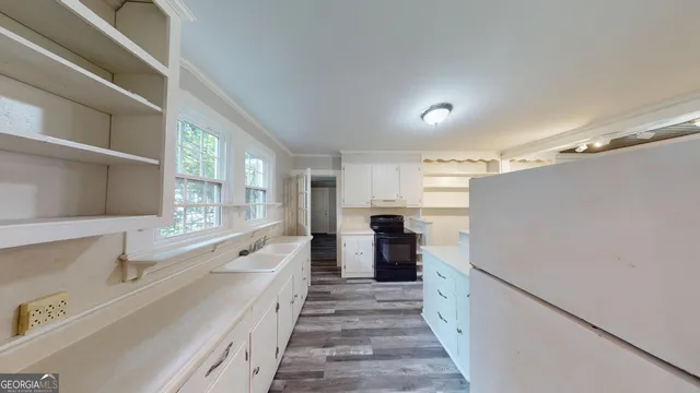 a kitchen with granite countertop a refrigerator and a sink