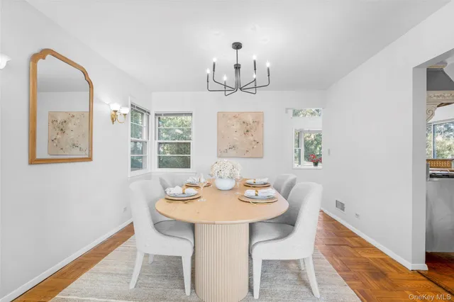 a view of a dining room with furniture window and wooden floor