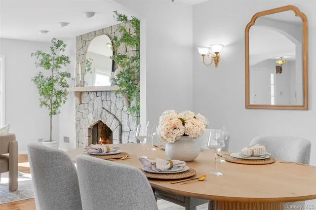 a living room with furniture fireplace and a potted plant