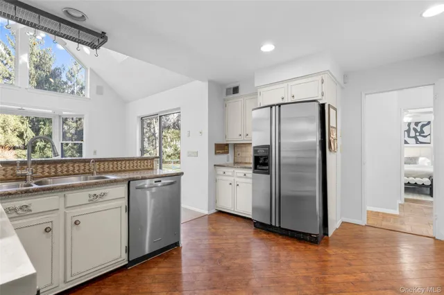 a kitchen with a refrigerator and a sink