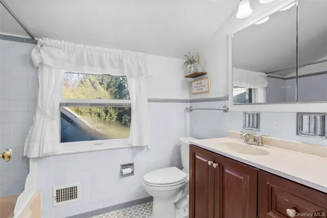 a bathroom with a sink a mirror and a toilet