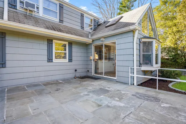 a view of a house with a backyard and porch