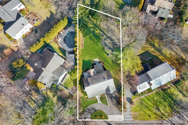 an aerial view of a house with a yard and plants