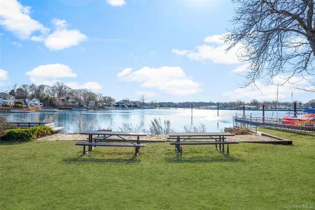 a swimming pool with outdoor seating and lake