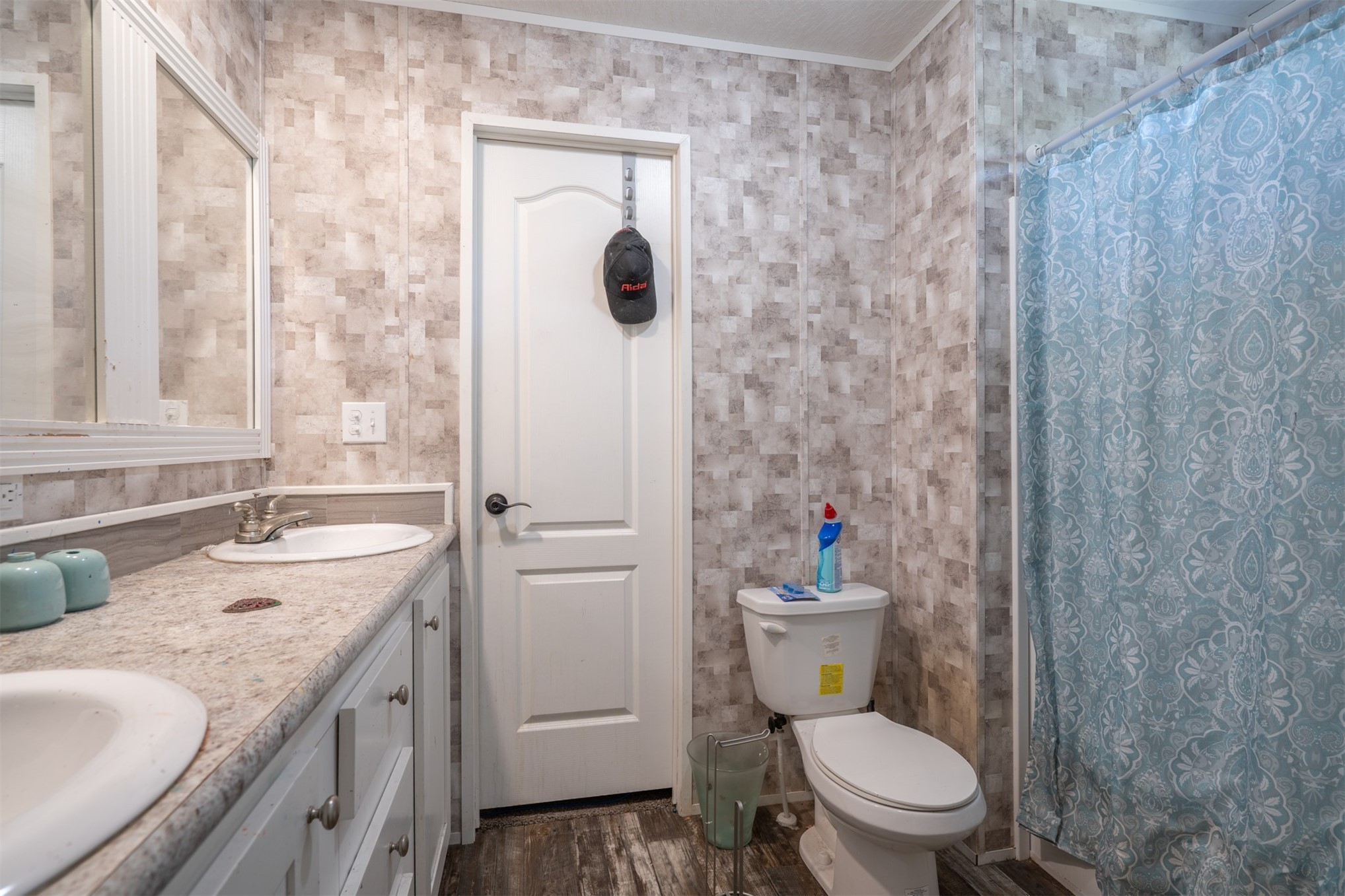 76220 Dove Road Yulee, FL 32097 - Photo 35 of 48 a bathroom with a granite countertop toilet a sink and a mirror