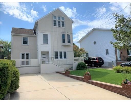 115 Fulton Spring Road Medford, MA 02155 - Photo 1 of 39 a front view of a house with a garden and plants