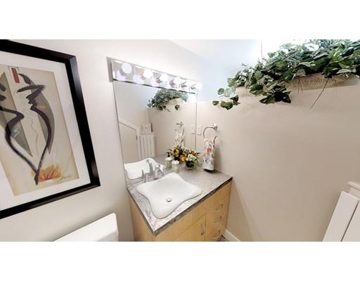 115 Fulton Spring Road Medford, MA 02155 - Photo 13 of 39 a bathroom with a sink mirror and vanity