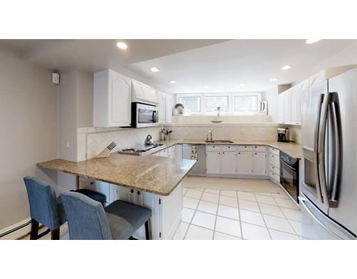 115 Fulton Spring Road Medford, MA 02155 - Photo 4 of 39 a kitchen with a sink a refrigerator and a stove top oven
