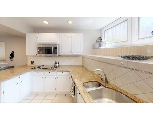 115 Fulton Spring Road Medford, MA 02155 - Photo 7 of 39 a kitchen with a sink a stove and cabinets