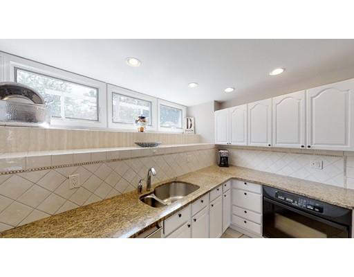 115 Fulton Spring Road Medford, MA 02155 - Photo 9 of 39 a kitchen with stainless steel appliances a sink stove and cabinets