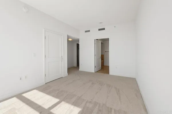 a spacious bathroom with a double vanity sink toilet and a mirror
