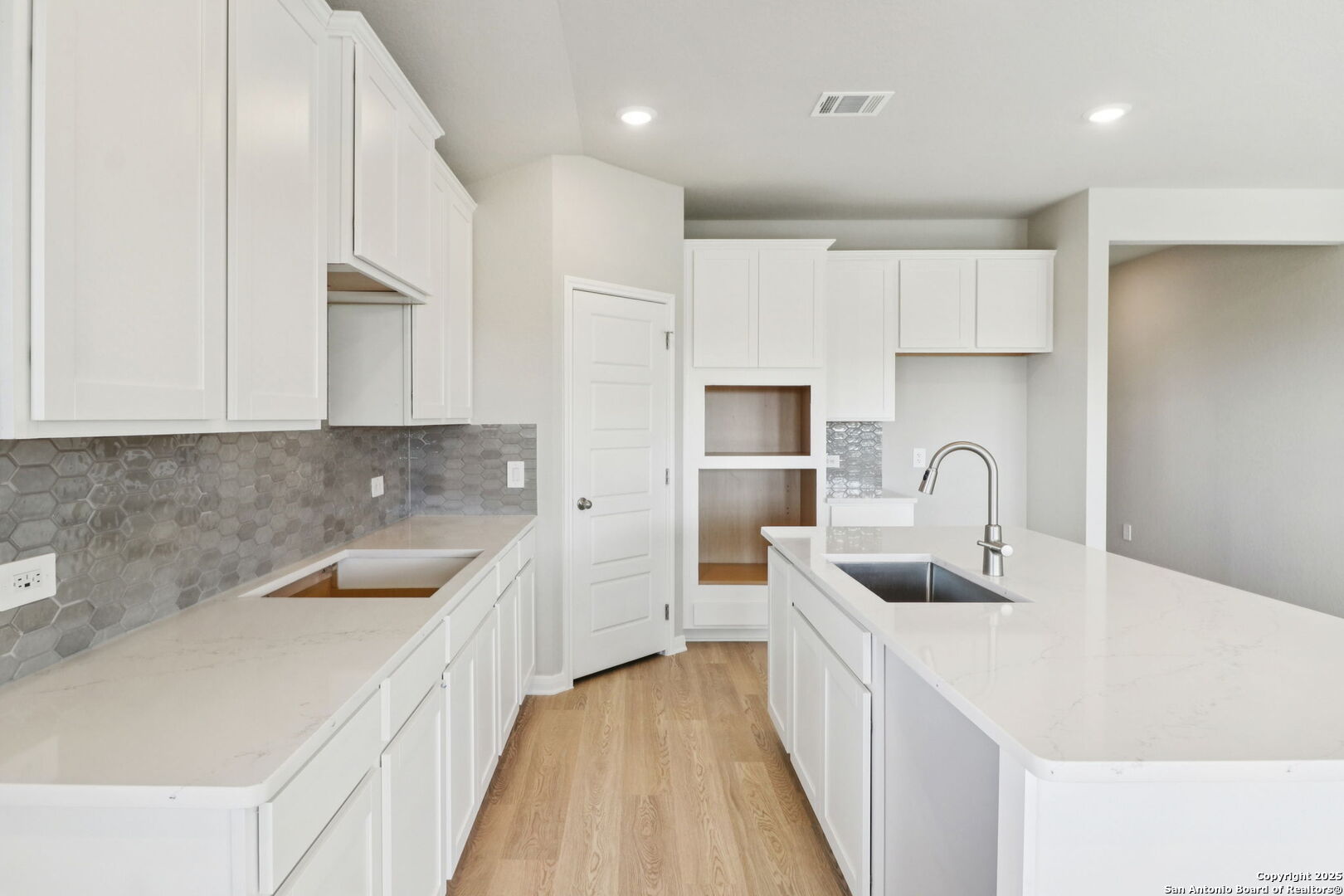 114 Dakota Ridge Cibolo, TX 78108 - Photo 12 of 39 a kitchen with stainless steel appliances a sink a stove top oven a counter space and cabinets