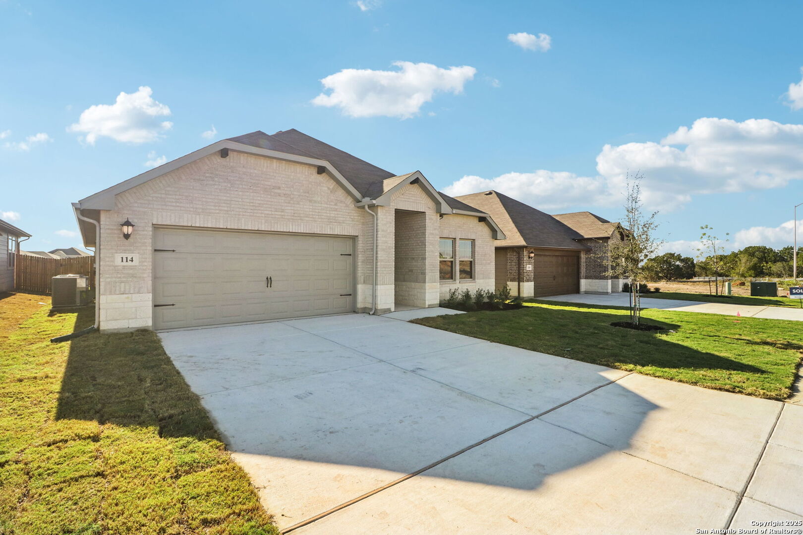 114 Dakota Ridge Cibolo, TX 78108 - Photo 2 of 39 a front view of a house with a yard and garage
