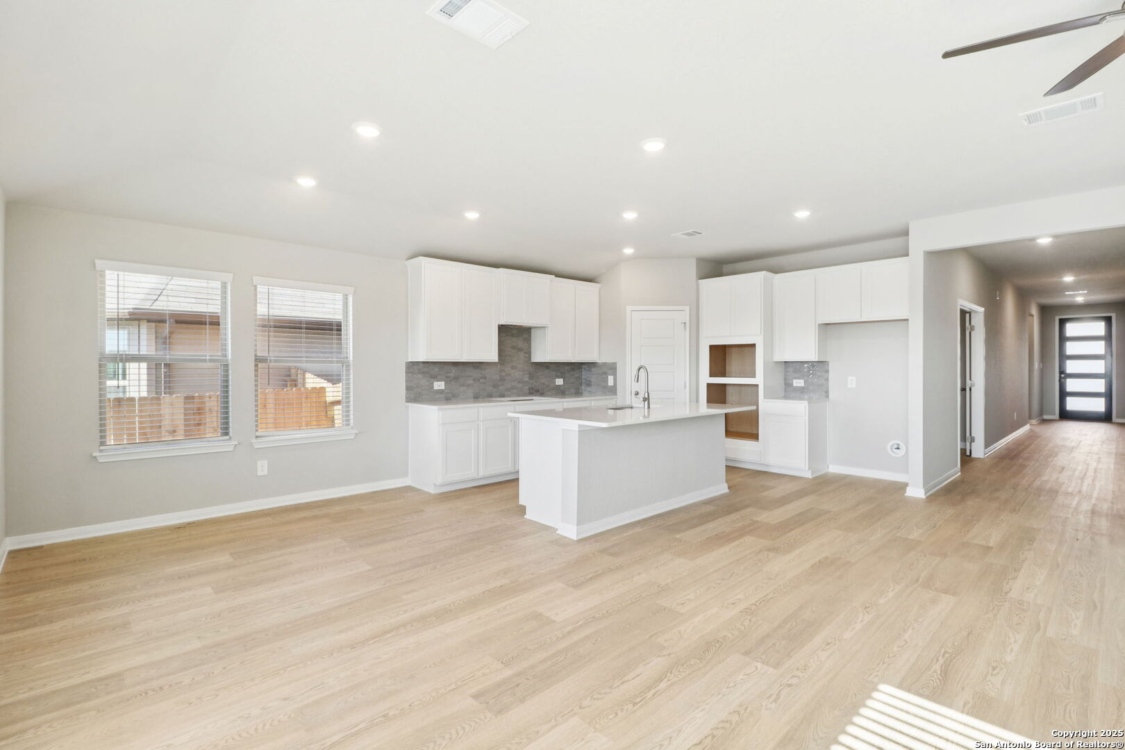 114 Dakota Ridge Cibolo, TX 78108 - Photo 10 of 39 a large kitchen with kitchen island white cabinets and stainless steel appliances
