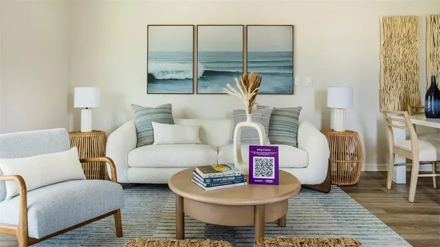 a living room with furniture and a floor to ceiling window