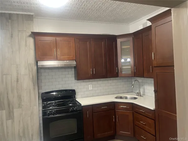 a kitchen with a sink stove and cabinets