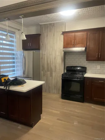 a kitchen with stainless steel appliances a stove and a refrigerator
