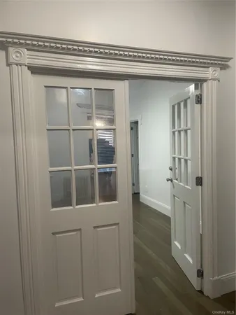 a view of a livingroom with wooden floor and windows