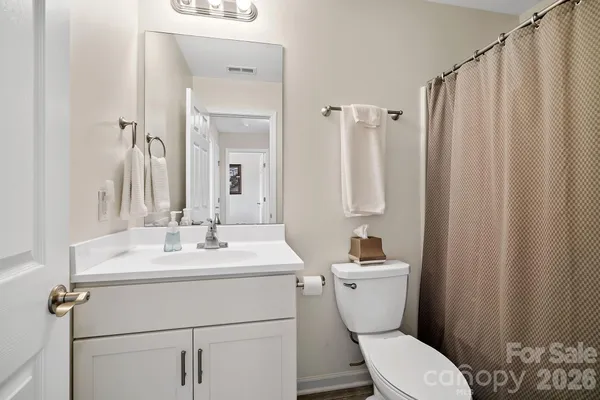 a bathroom with a sink a toilet and a mirror