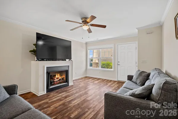 a living room with furniture a flat screen tv and a fireplace