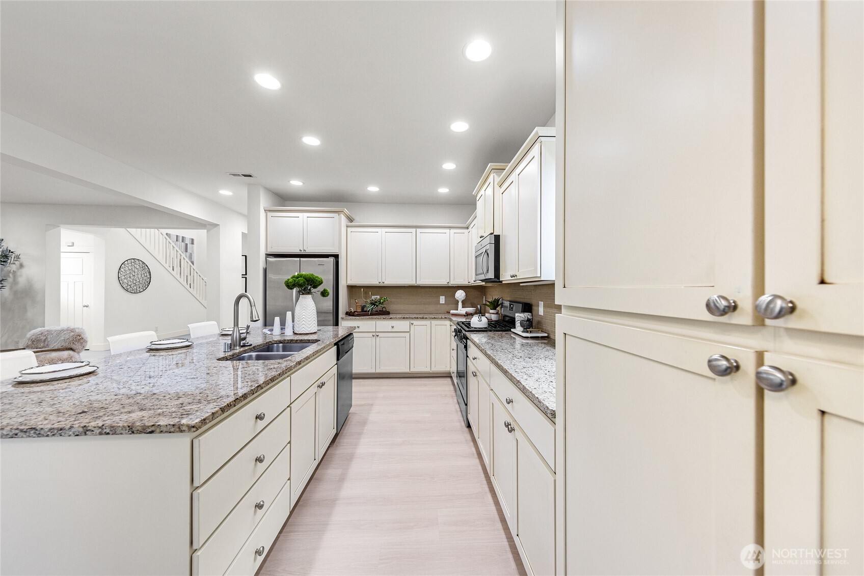 4115 176th Place Southeast Bothell, WA 98012 - Photo 12 of 35 a kitchen with kitchen island granite countertop a sink stove and refrigerator