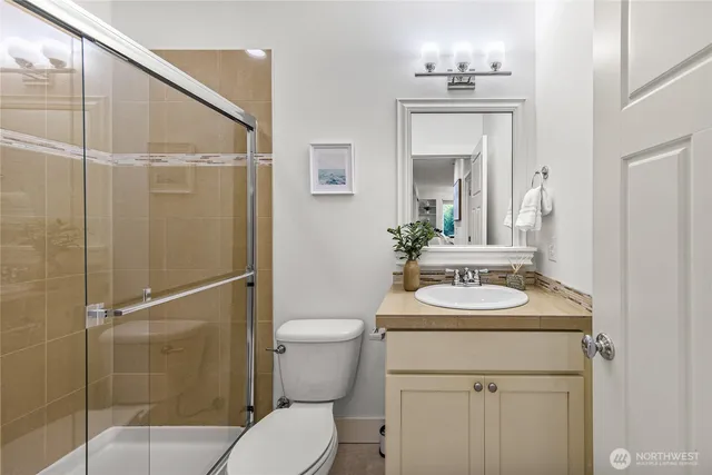 a bathroom with a sink toilet and shower