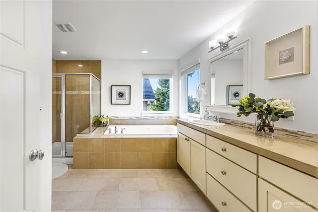 a bathroom with a tub sink and mirror