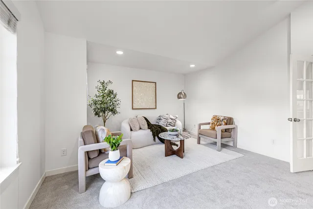 a living room with furniture potted plant and a window