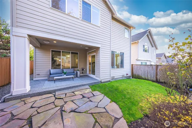 a view of a house with backyard and porch