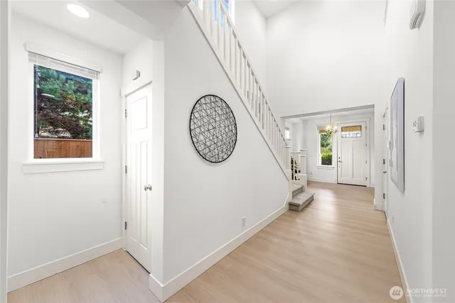 a view of a hallway with windows and entryway