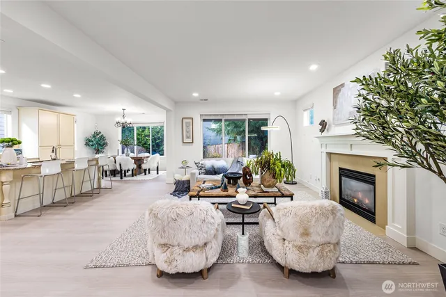 a living room with furniture a fireplace and a table
