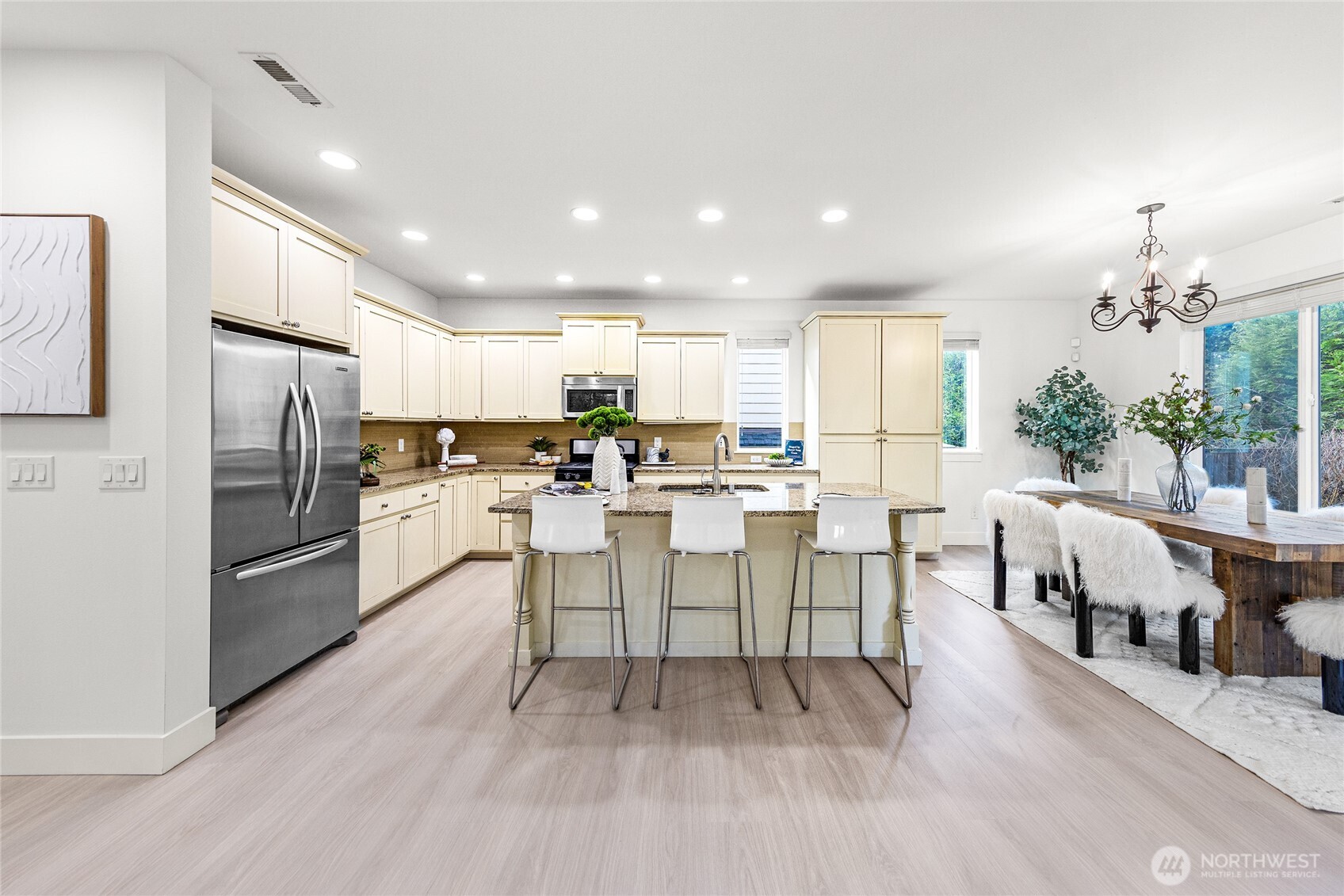 4115 176th Place Southeast Bothell, WA 98012 - Photo 10 of 35 a kitchen with stainless steel appliances a refrigerator a stove a sink dishwasher with a dining table and chairs
