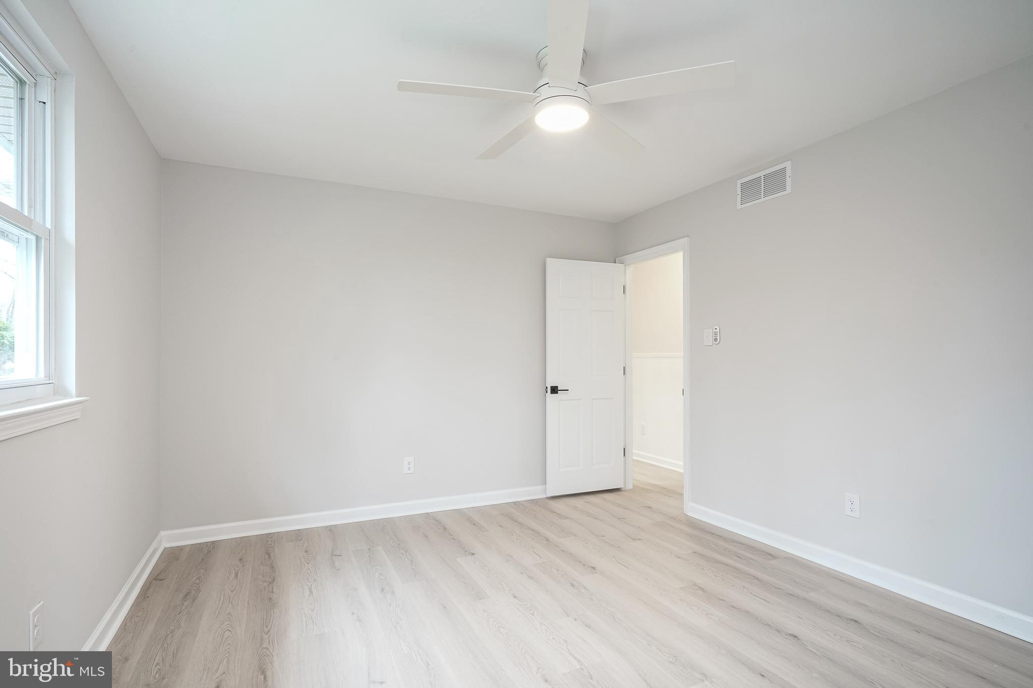 3 Alberts Avenue Sicklerville, NJ 08081 - Photo 16 of 36 an empty room with wooden floor and windows
