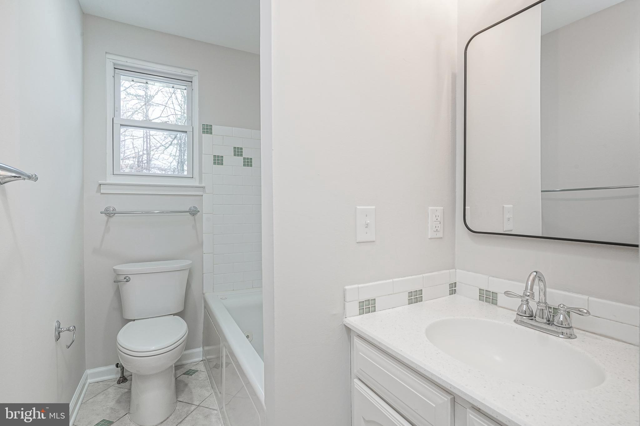 3 Alberts Avenue Sicklerville, NJ 08081 - Photo 24 of 36 a bathroom with a toilet sink vanity and mirror