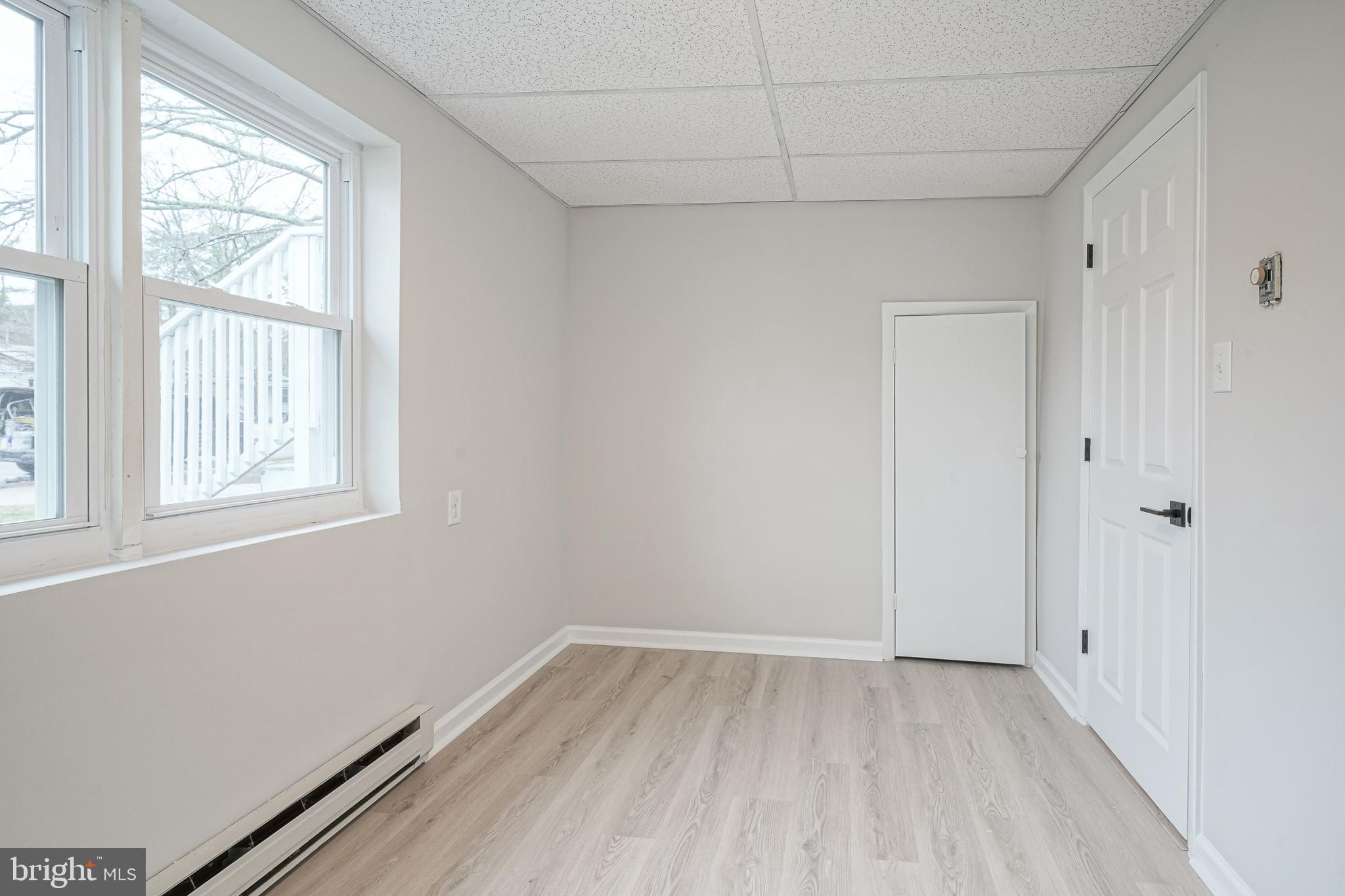 3 Alberts Avenue Sicklerville, NJ 08081 - Photo 31 of 36 an empty room with wooden floor and windows