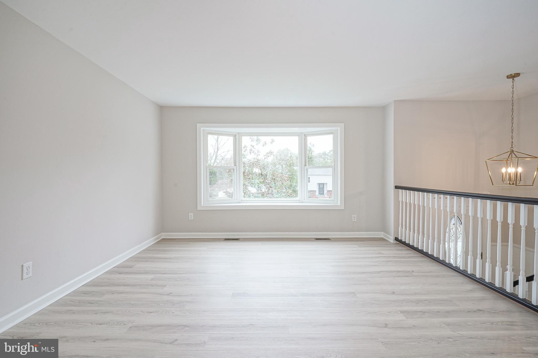 3 Alberts Avenue Sicklerville, NJ 08081 - Photo 6 of 36 a view of an empty room with wooden floor and a window