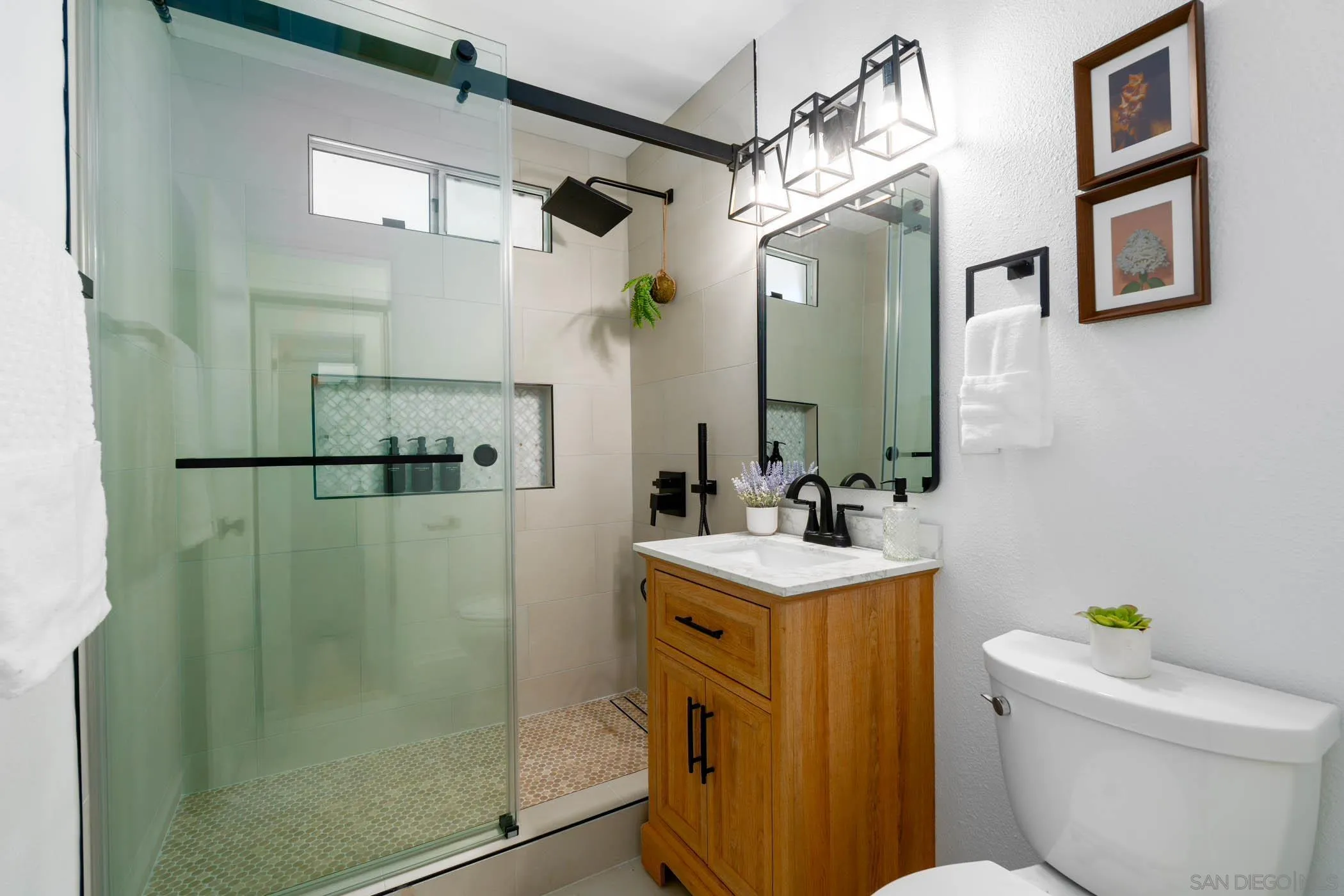 12918 Seiler Street Poway, CA 92064 - Photo 13 of 25 a bathroom with a sink a toilet a mirror a vanity and shower
